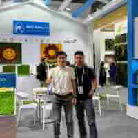 Two Asian men posing for a photo at the booth